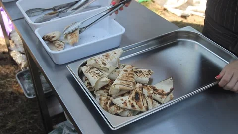 The chef's hands put on pita  . Preparing street food in cafe. Tasty pita with v Stock Footage 153478343