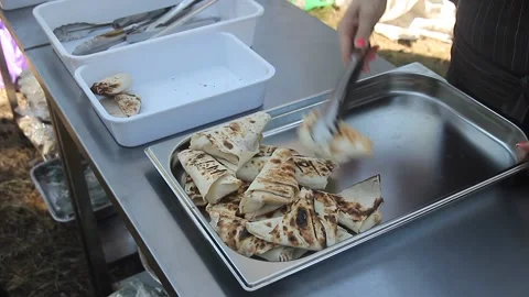 The chef's hands put on pita  . Preparing street food in cafe. Tasty pita with v Stock Footage 158451358