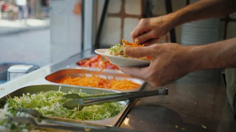 Chef's hands puts vegetables and salad on a plate, Turkish street food Stock Footage 219497595
