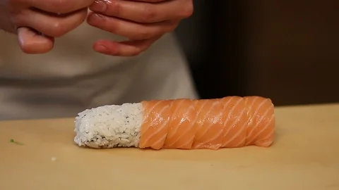 Chef's hands rolling a sushi roll. Sushi making process. Rolls the sushi roll Stock Footage 126049421
