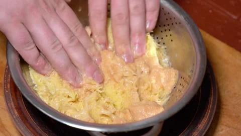 Chef's hands shaking grated raw potatoes Stock Footage 247845362