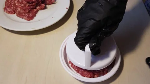 Chef's Hands Shaping Beef Burger Patty With A Patty Molder. overhead shot Video stock 148800238