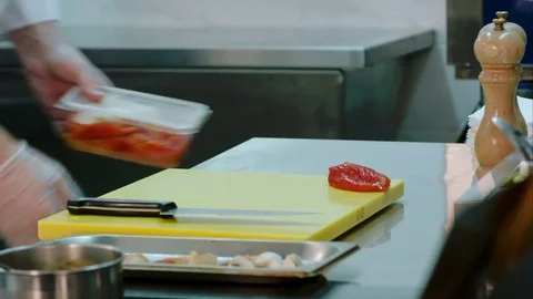 Chef's hands slicing cured red bell pepper and putting it together with other Video stock 72327142