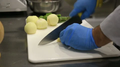 Chef's hands slicing onion close up view. Stock Footage 144510680