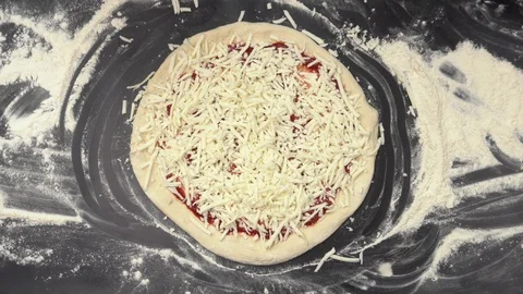 The chef's hands spread the salami slices in a circle on the pizza. The view Stock Footage 123420511