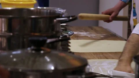 Chefs hands unrolling dough with a rolling pin in kitchen Stock Footage 49068749