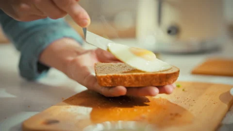 Chefs hands whisk eggs spread them on toast and sprinkle fresh herbs in brig Stock Footage 334546286