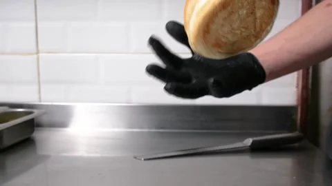 The chef's in the kitchen, tossing hamburger buns in the air. Stock Footage 278348163