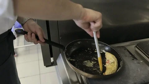 Chefs mix omelette with vegetables using a special technique Stock Footage 77480891