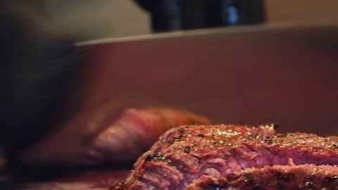 Chef's Precision: Slicing Grilled Beef for Delivery Containers – Close-Up Stock Footage 288690506