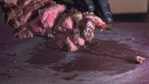 Chef's Precision: Slicing Grilled Beef for Delivery Containers – Close-Up Stock Footage 288690795