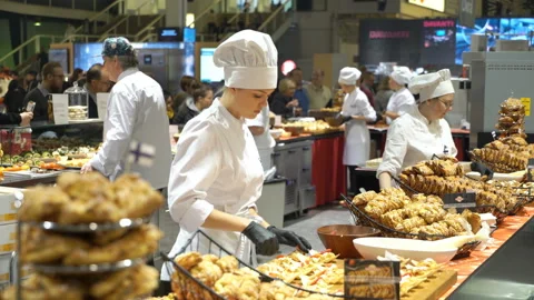 The chefs prepare food samples and treat visitors during the Food Show Stock Footage 87423095