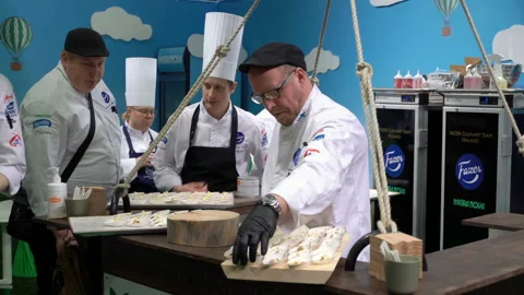 The chefs prepare food samples and treat visitors Stock Footage 127803988