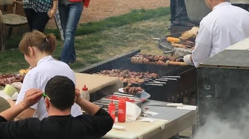 Chefs prepare meals in the open air Stock Footage 85670488