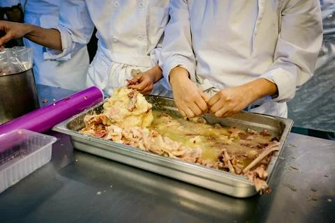 Chefs processing meat in a professional kitchen Stock Photos