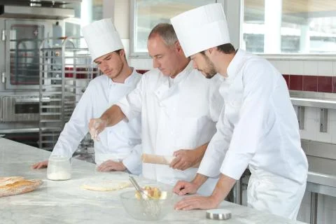 Chefs in the school kitchen Stock Photos