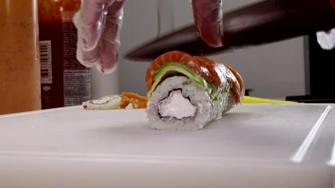 Chef's sharp knife cuts sushi Stock Footage 285251046