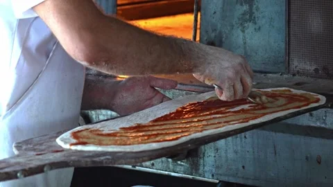 Chefs Skillfully Preparing a Delicious Pizza with Fresh Cheese in an Authentic Stock Footage 311993857