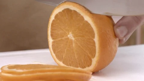 Chef's slicing orange Stock Footage 93846615