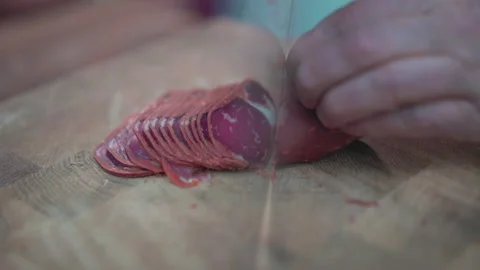 A chef's slicing Turkish bacon. Video stock 146637718