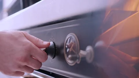 The chef's turning on the oven. Stock Footage 136878622