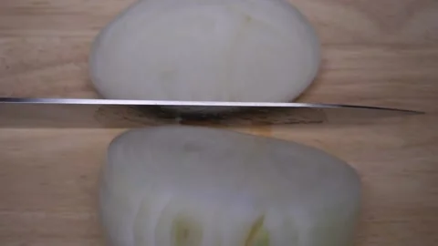 Chefs use a kitchen knife to chop the onions on a wooden cutting board to cut Stock Footage 160522631