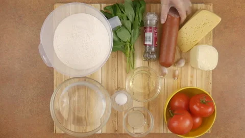 The chefs womans hands alternately remove all the ingredients for the Stock Footage 136741259