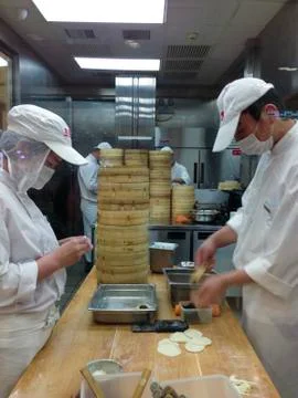 Chefs at work in a Chinese restaurant kitchen Stock Photos