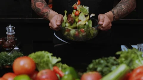 Chefs at work in a restaurant kitchen cooking salad culinary cutting delicious Stock Footage 100303410