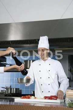 Chefs working in a kitchen Stock Photos