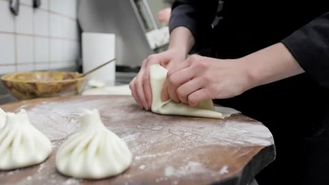 Chefs Wrap Filling in Dough to Make Khinkali in Slow Motion Stock Footage 288575784