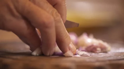 Chefs's hands chop onion with knife Stock Footage 258275090