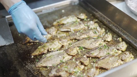 Chelf using spatula to grill fish Stock Footage 194520931