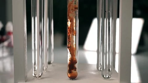 The chemical brown reagent slowly dissolves in a test tube with a clear liquid Video stock 188749494