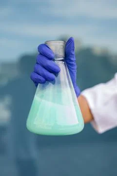 A chemical conical flask with a blue solution Stock Photos
