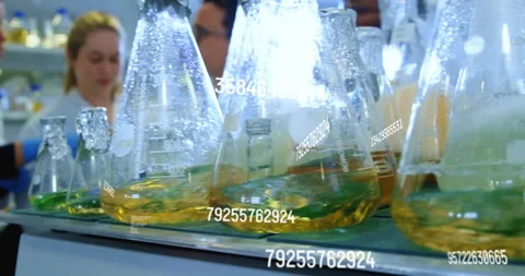 Chemical data animation over laboratory flasks with yellow liquid Stock Footage 306273562