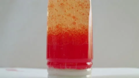 Chemical experience. in a bottle of oil, a solution of chemicals with dyes boils Stock Footage 152089894