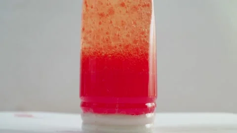 Chemical experience. in a bottle of oil, a solution of chemicals with dyes boils Stock Footage 153929529