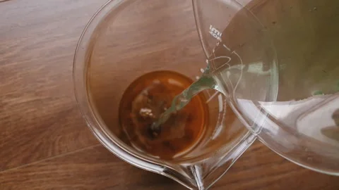 Chemical experiments, pouring green liquid into brown. Stock Footage 138664183