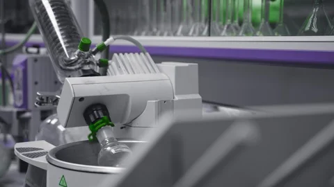 Chemical flask rotates to mix components in lab. Medical or pharmacy industry. Stock Footage 104583182