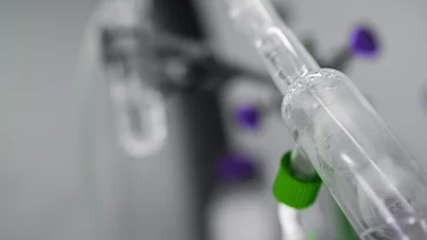 Chemical liquids in lab processes: mixing, reaction, solution in glass tubes Stock Footage 104583125
