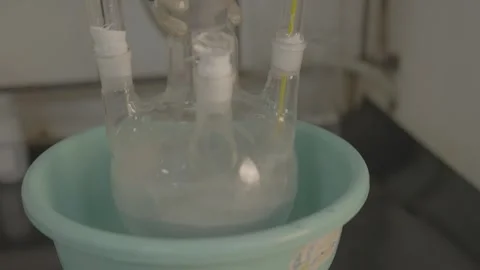 Chemical mixing process in a multi-neck flask in a lab Stock-Footage 327633509