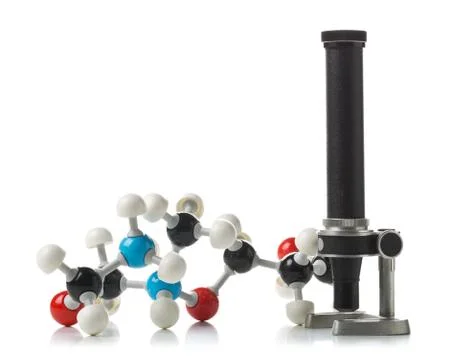 Chemical molecule model with old microscope over white background Stock Photos