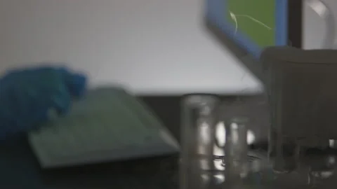 Chemical Solution Bubbles as Scientist Inputs Information Into a Computer Stock Footage 208708701