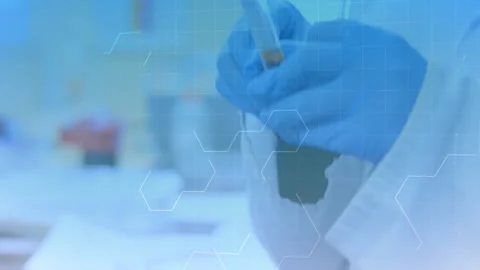 Chemical structure moving against mid section of scientist holding test tubes in Stock Footage 141057271