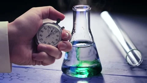 Chemical tubes, reaction formulas and stopwatch in a hand Stock Footage 235154553