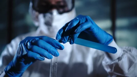 Chemist Adding Chemicals into a Mixing Flask Experiment. High technology Stock Footage 95090555
