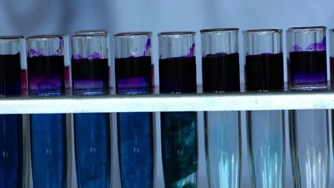 Chemist adds decolorizing reagent into blue dye solution Stock Footage 77208777