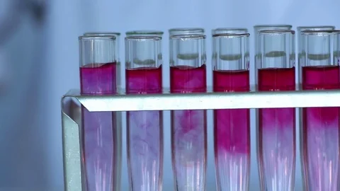 Chemist adds decolorizing reagent into red dye solution Stock Footage 77208847