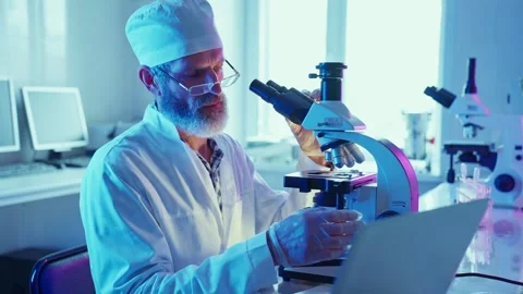 Chemist Analyzing Samples With Modern Equipment in Research Laboratory at Night Stock Footage 282507701
